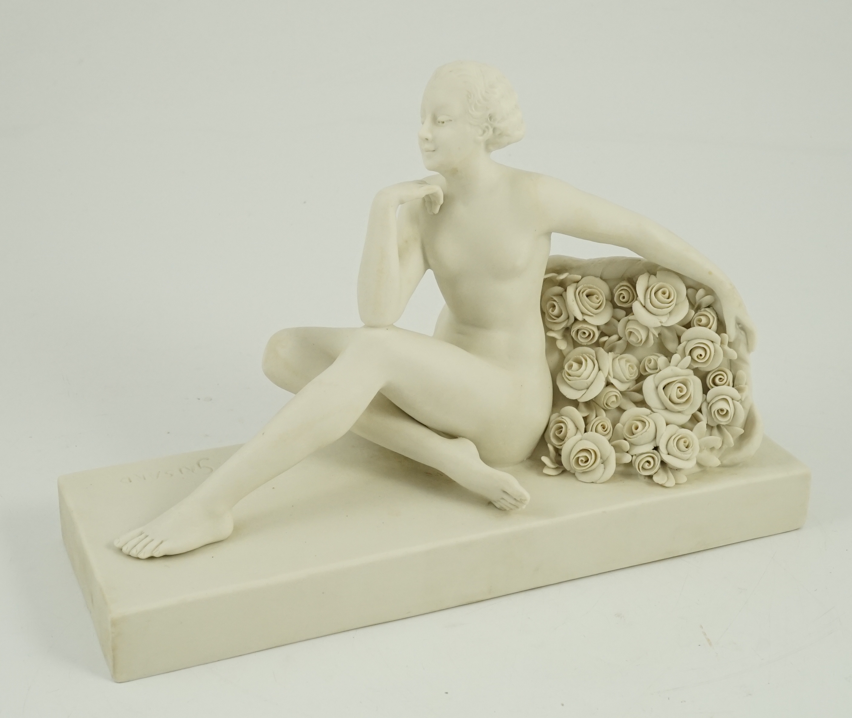 Henri Désiré Grisard (1872 - active until 1940). A signed bisque model of a seated nude by flowers, 1920s